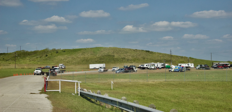 The tucked-away entrance to Texas World—a grassy hill behind which the grandstands sit.